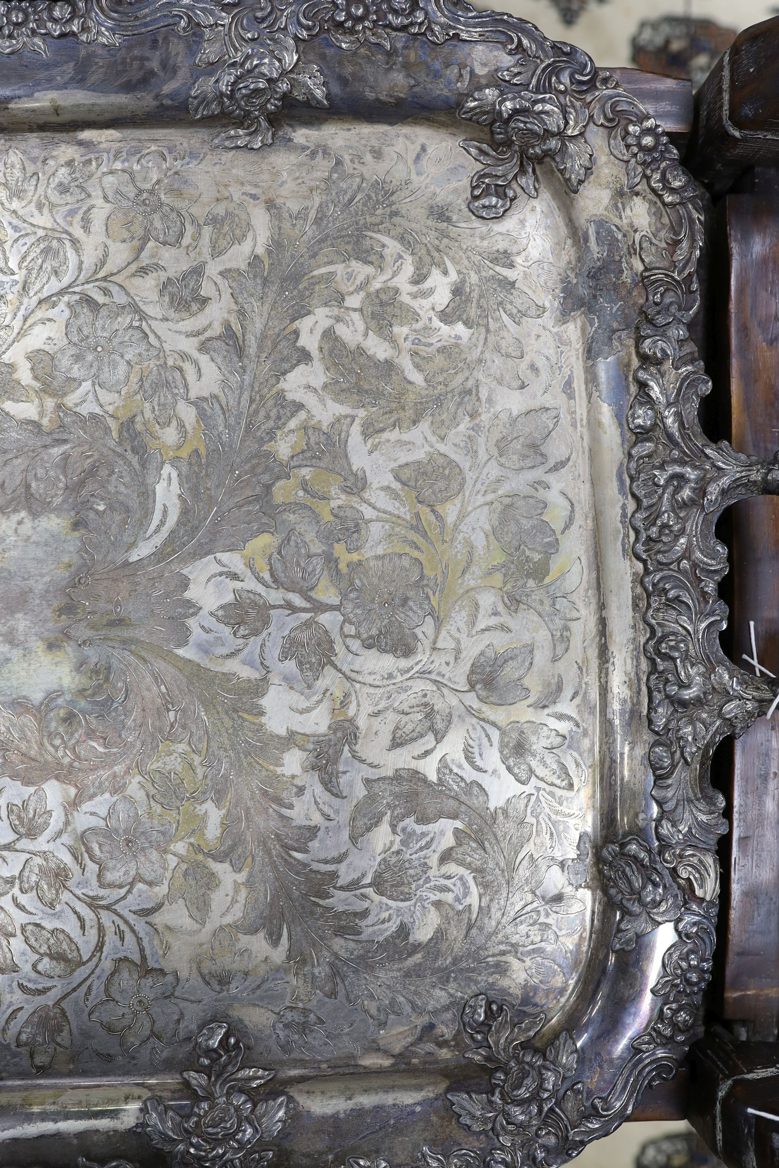 A large two handled silver plated tray with ornate floral edge, 87 cms wide.